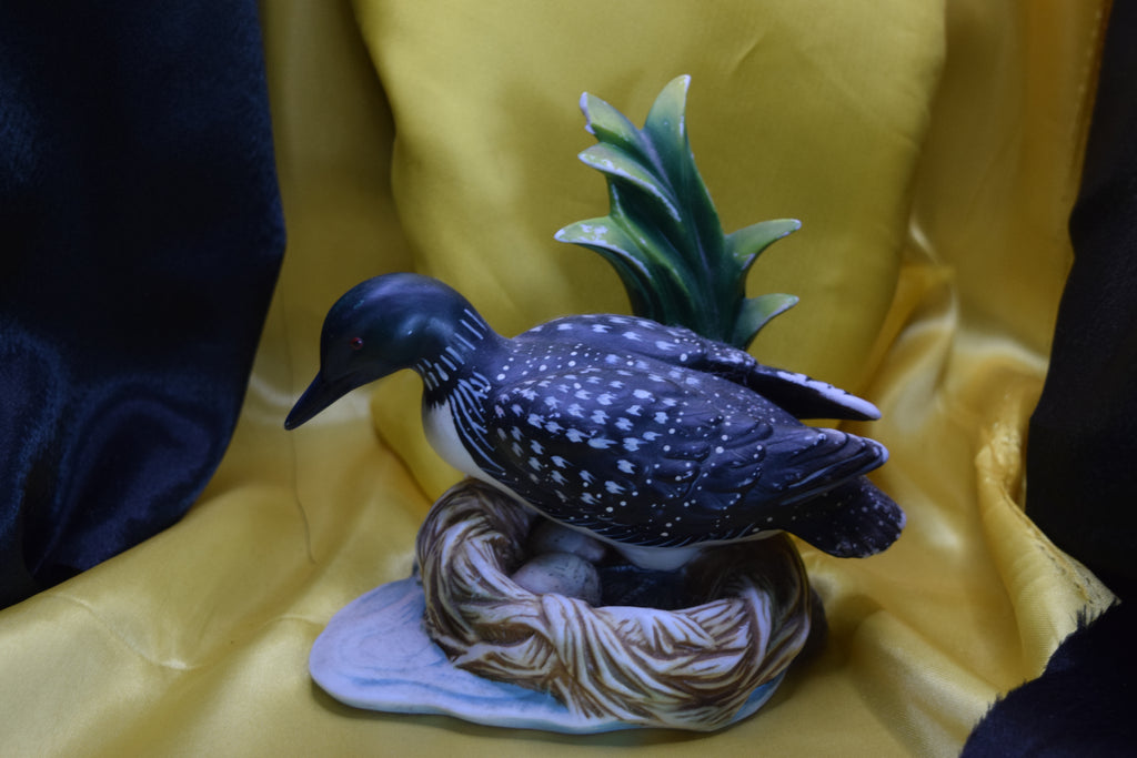Ceramic wood duck sitting on a nest