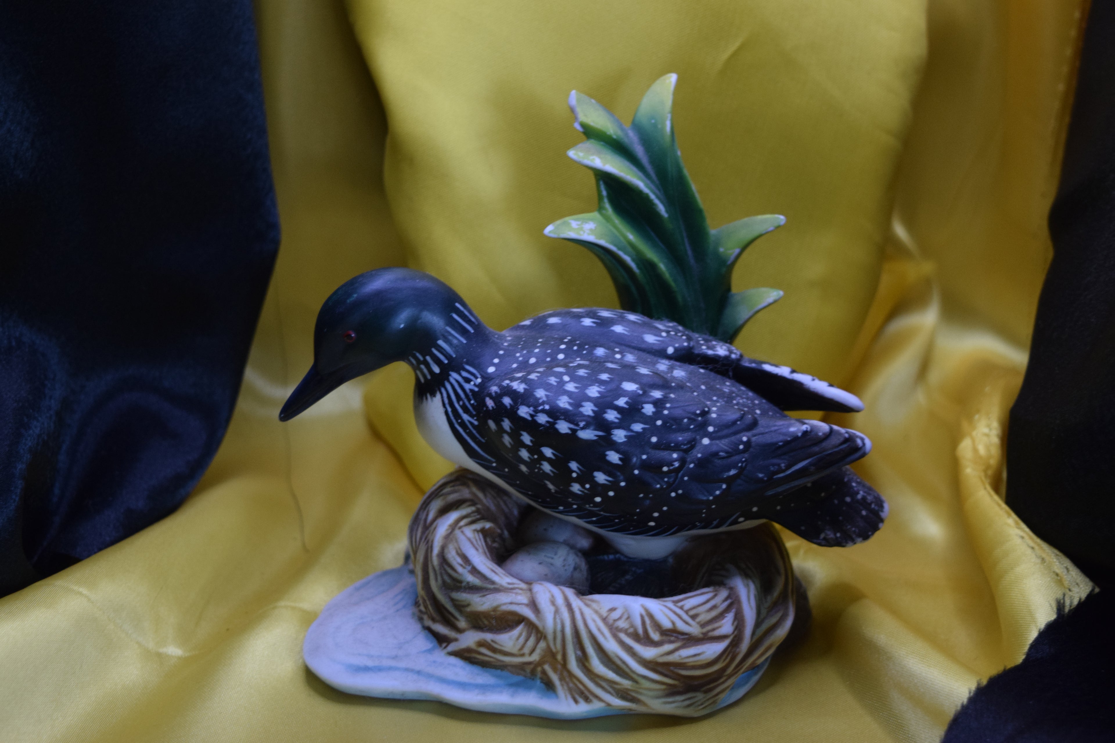 Ceramic wood duck sitting on a nest
