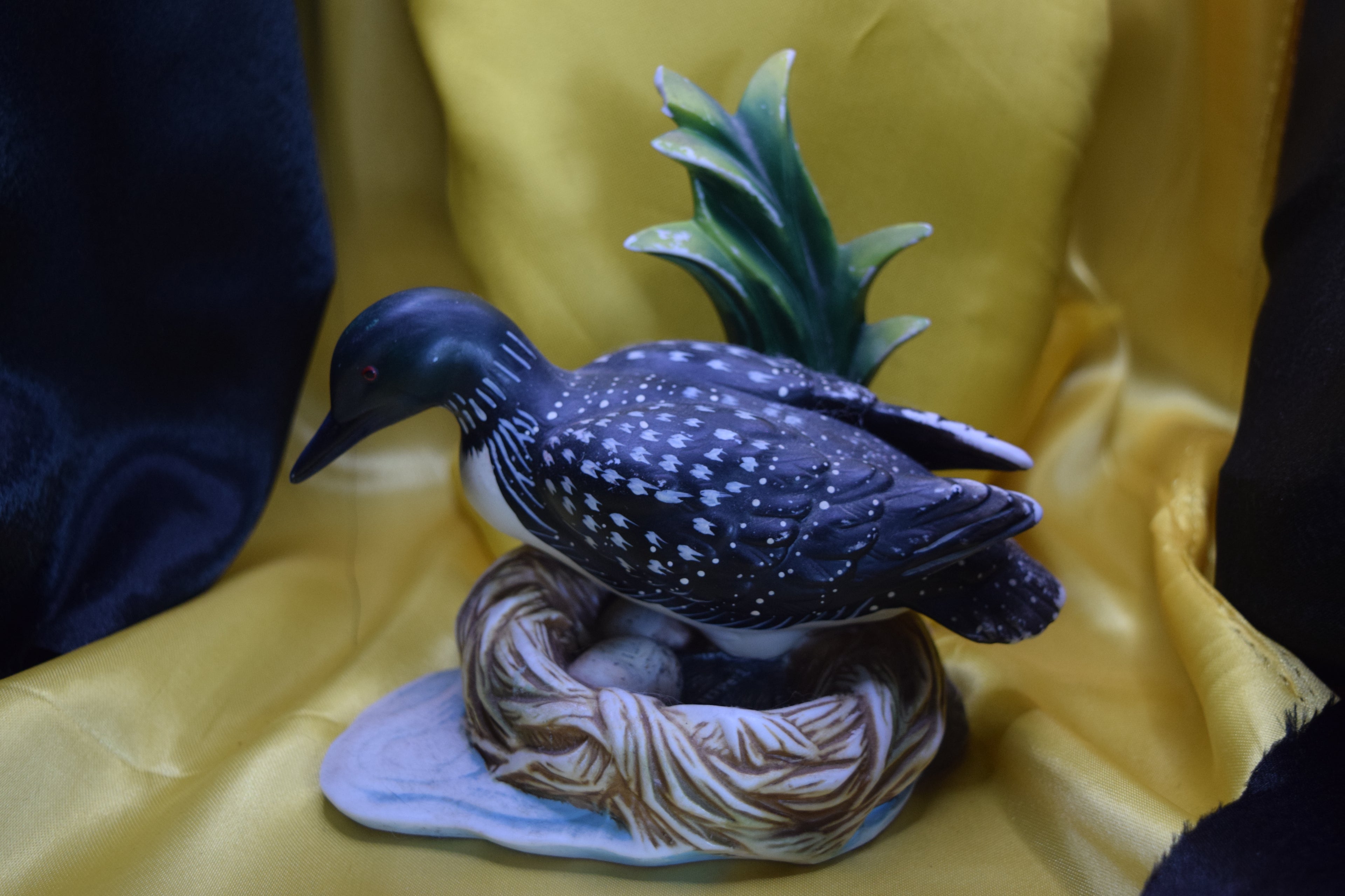 Ceramic wood duck sitting on a nest