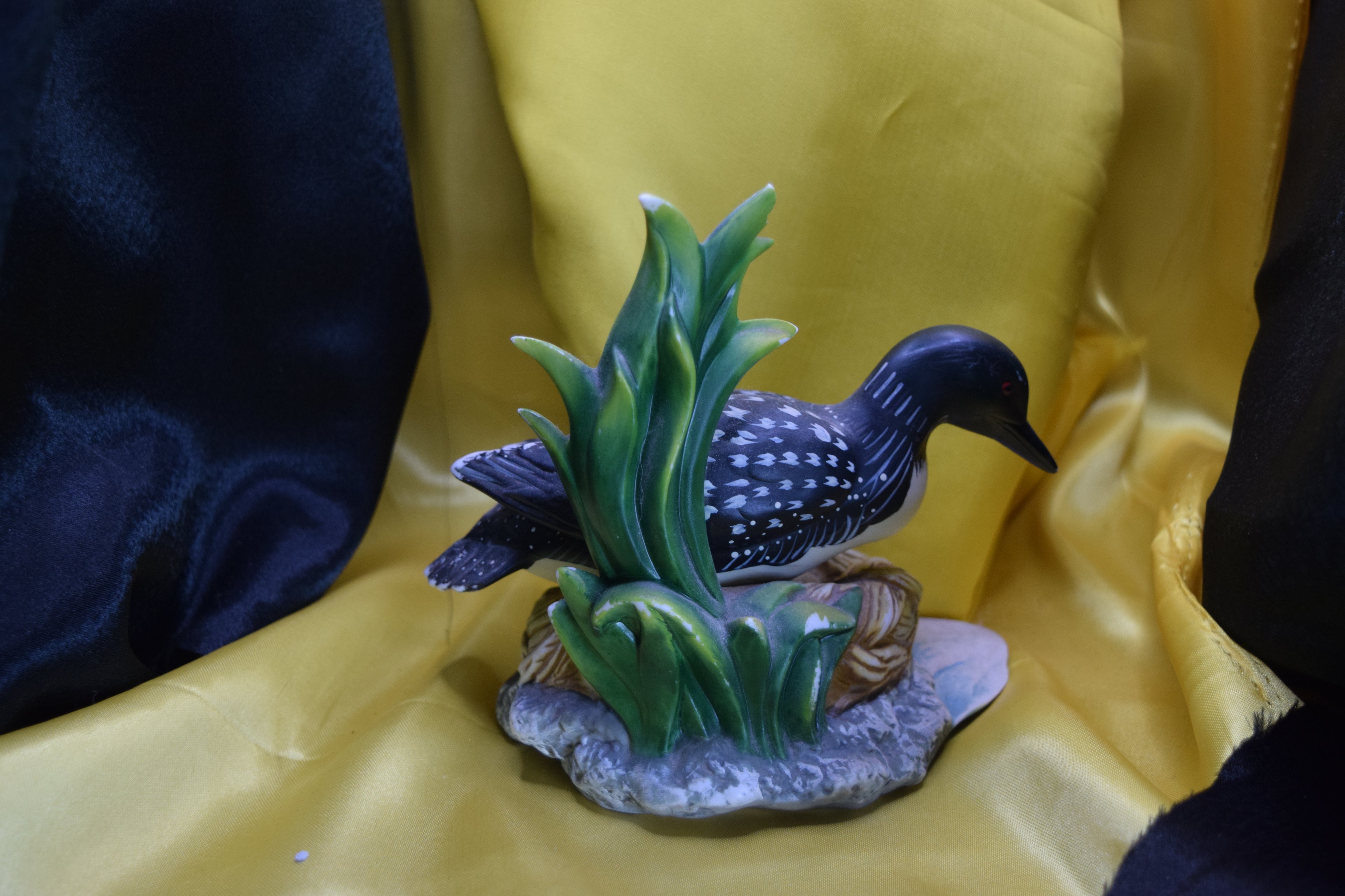 Ceramic wood duck sitting on a nest