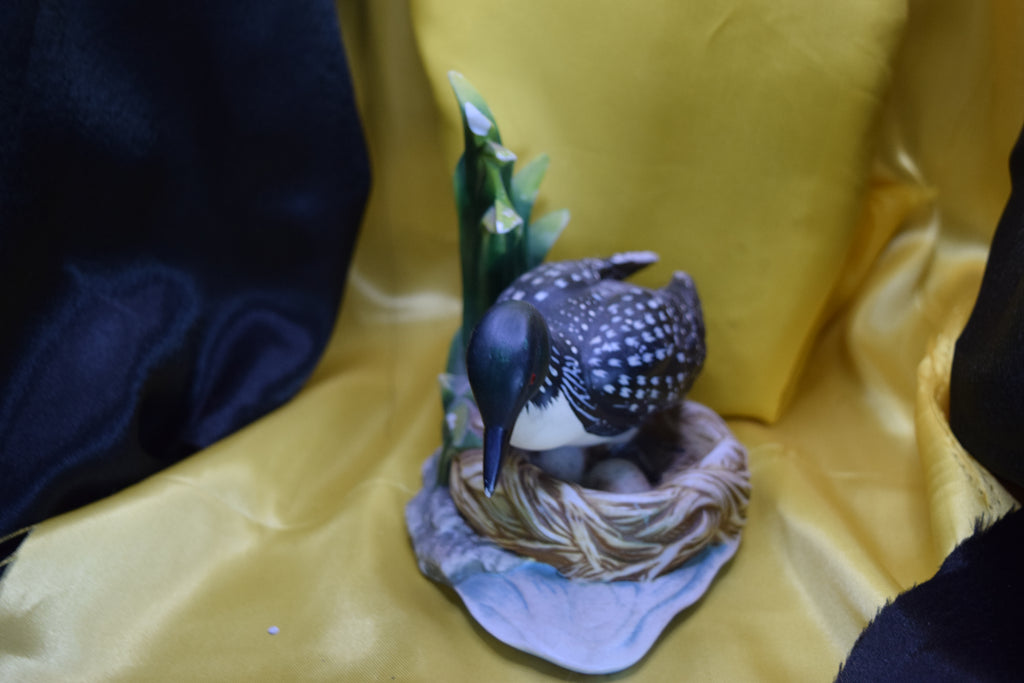 Ceramic wood duck sitting on a nest
