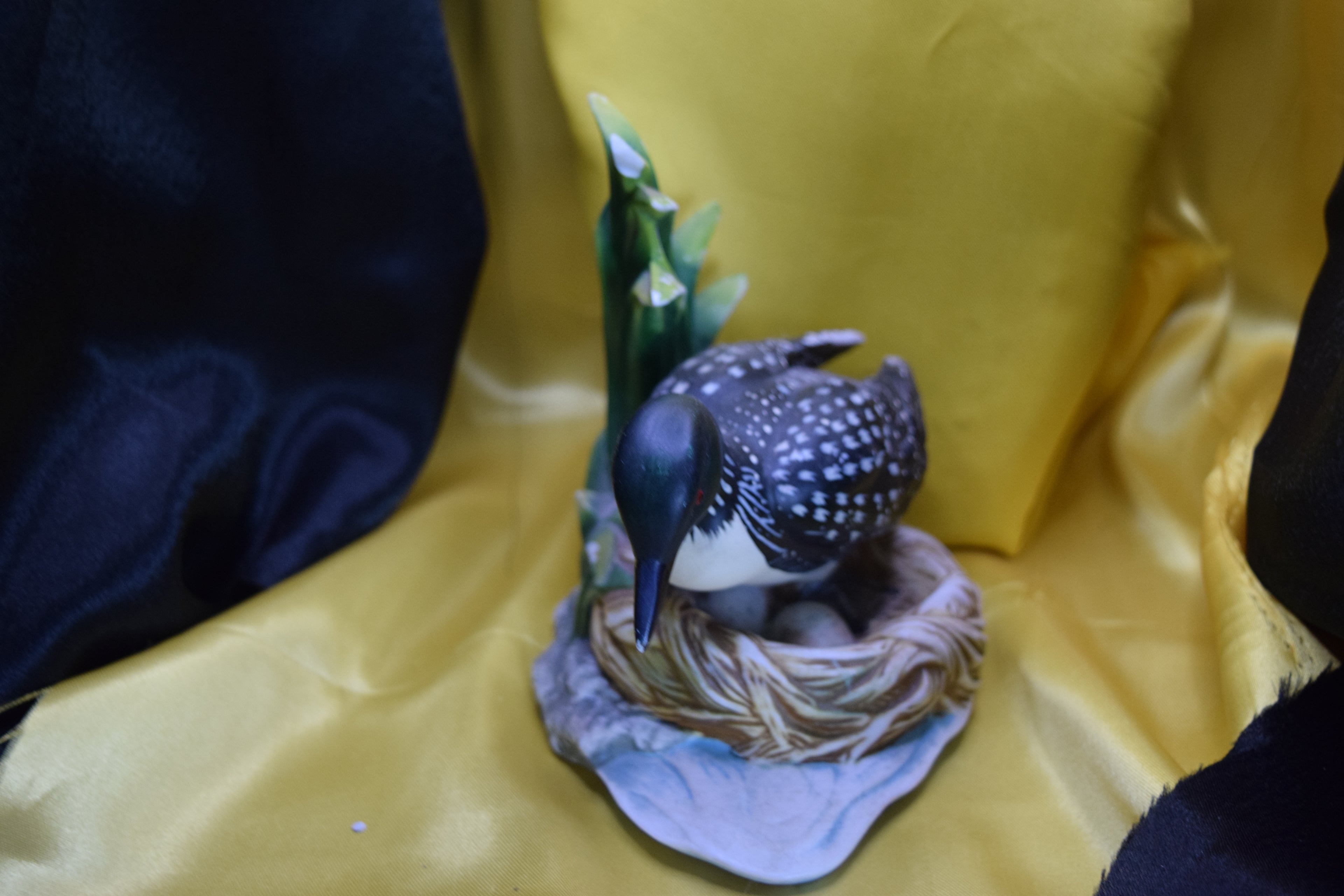 Ceramic wood duck sitting on a nest